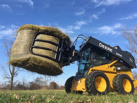 john deere skid steer in the hay|round bales skid steer.